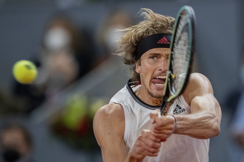 Germany's Alexander Zverev returns the ball to Italy's Matteo Berrettini during the men's final match at the Mutua Madrid Open tennis tournament in Madrid, Spain, Sunday, May 9, 2021. (AP Photo/Bernat Armangue)