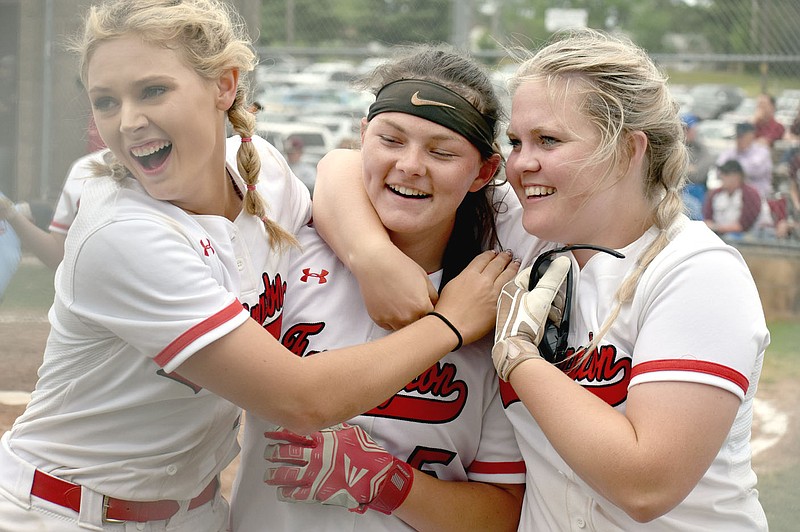 MARK HUMPHREY  ENTERPRISE-LEADER/Farmington seniors Shayley Treat (left) and Grace Boatright (right) celebrate sophomore Kamryn Uher's clutch, two-out, two-strike, solo home run in the bottom of the seventh inning that tied the game 2-2 and gave the Lady Cardinals' new life. Despite that and another solo homer by Treat to start the sixth, Farmington lost 3-2, in eight innings to Morrilton Friday during the 4A North Regional softball tournament held at Harrison. The Lady Cardinals take a No. 3 seed into this week's state tournament at Morrilton. They begin state play on Thursday against Valley View at 5:30 p.m.