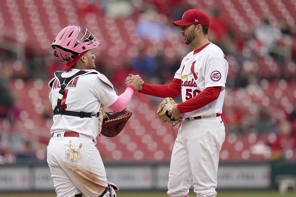 St. Louis Cardinals starting pitcher Adam Wainwright, right, is congratulated by teammate Yadier Molina before being removed during the ninth inning of a baseball game against the Colorado Rockies Sunday, May 9, 2021, in St. Louis. (AP Photo/Jeff Roberson)