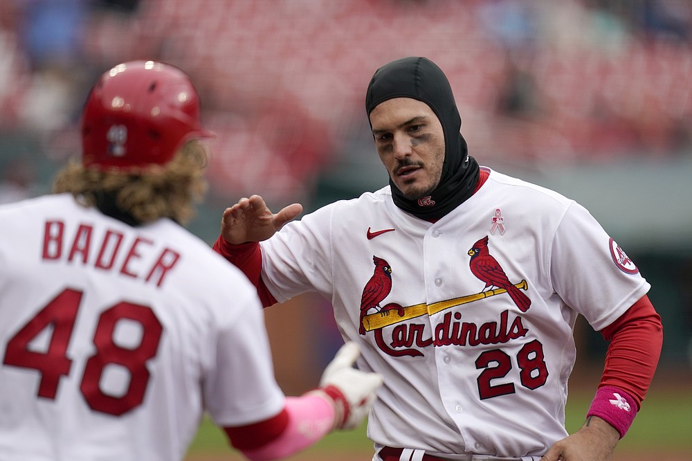 St. Louis Cardinals' Nolan Arenado (28) is congratulated by teammate Harrison Bader (48) after scoring during the fourth inning of a baseball game against the Colorado Rockies Sunday, May 9, 2021, in St. Louis. (AP Photo/Jeff Roberson)