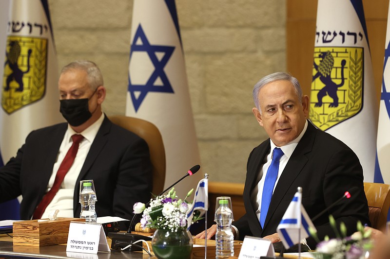 Israeli Prime Minister Benjamin Netanyahu, right, and Minister of Defense Benny Gantz  attend a special cabinet meeting on the occasion of Jerusalem Day, at the Jerusalem Municipality building, in Jerusalem, Sunday, May 9, 2021. (Amit Shabi/Pool Photo via AP)