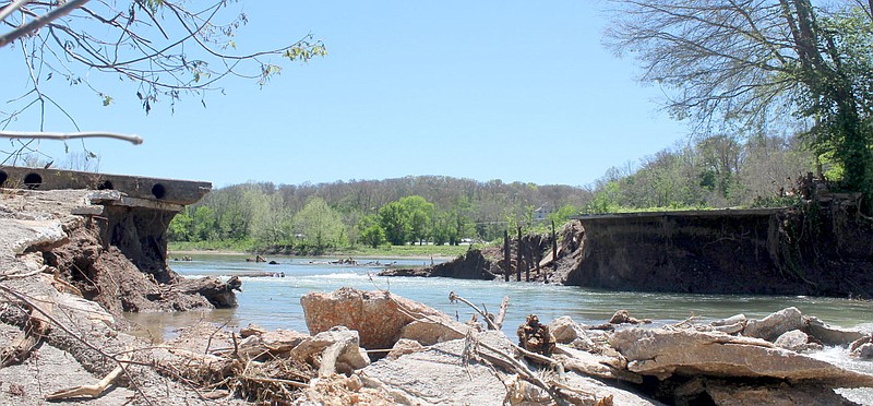 Keith Bryant/The Weekly Vista
Heavy floodwaters breached the Lake Bella Vista Dam, leaving a massive gap roughly in the center of the structure. The dam was previously closed and a portion of the Lake Bella Vista trail has been closed as well.