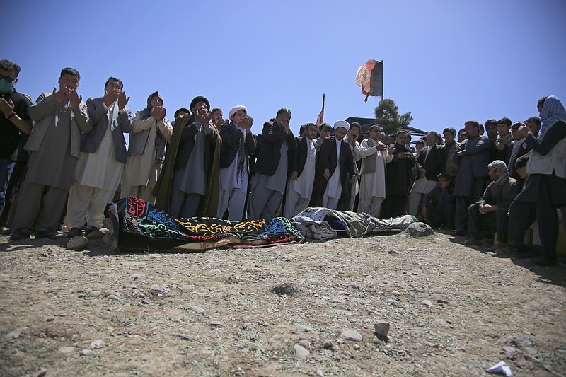 Afghans pray during the funeral of victims of deadly bombings on Saturday near a school, at a cemetery west of Kabul, Afghanistan, Sunday, May 9, 2021. The Interior Ministry said Sunday the death toll in the horrific bombing at the entrance to a girls' school in the Afghan capital has soared to some 50 people, many of them pupils between 11 and 15 years old, and the number of wounded in Saturday's attack has also climbed to more than 100. (AP Photo/Mariam Zuhaib)