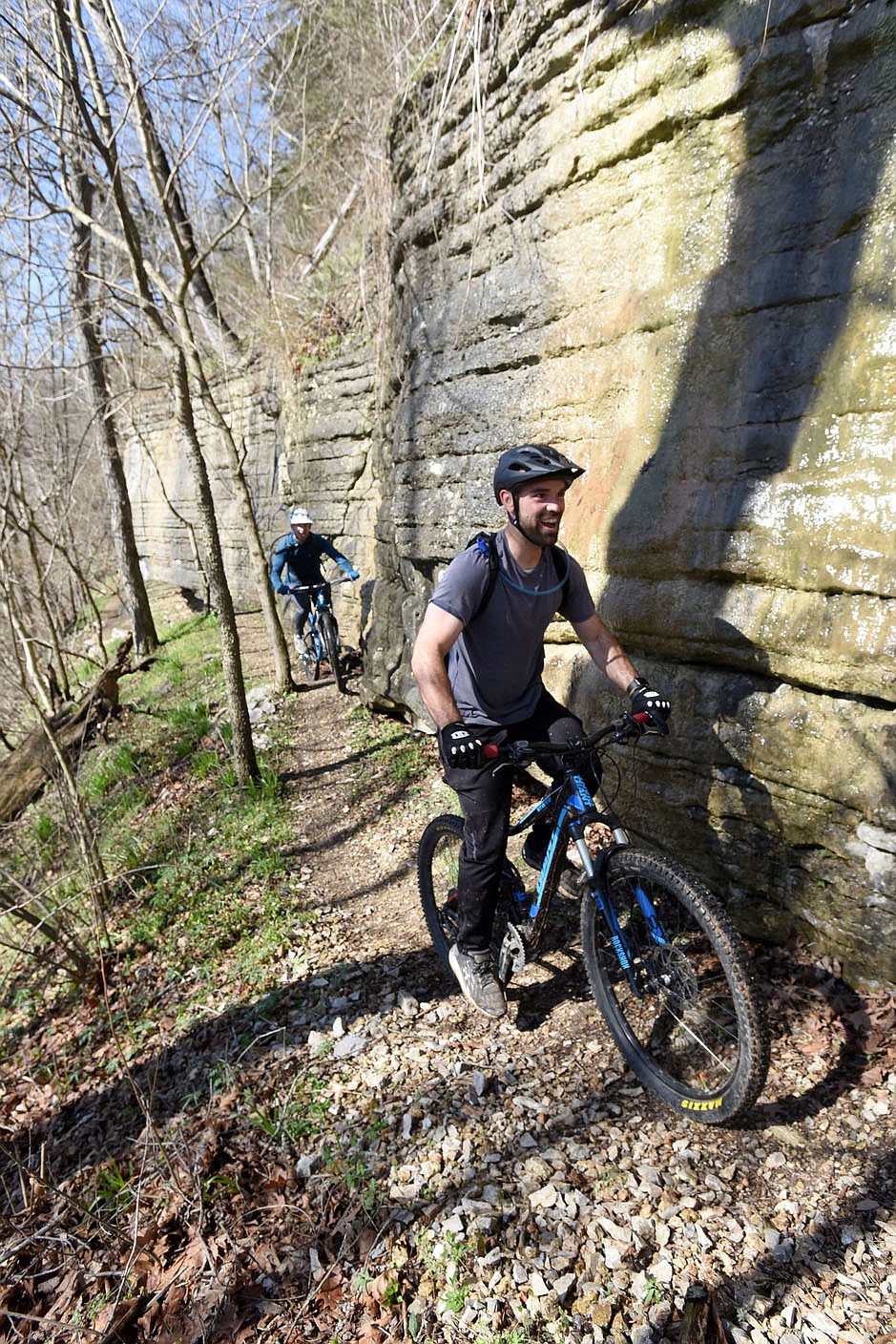 Jake Endicott of Carthage, Mo. and Brian Obermann (right) navigate March 26 2021 the Danger Will Robinson trail, part of the Little Sugar trail system in Bella Vista.
(NWA Democrat-Gazette/Flip Putthoff)
