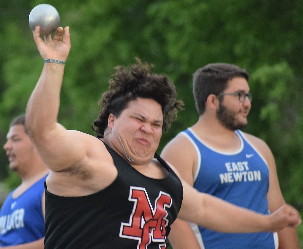 McDonald County's Kaidan Campbell strains on a throw in the shot put at the Big 8 Conference Track and Field Championships held on May 5 at Monett High School. Campbell finished the event in seventh place.