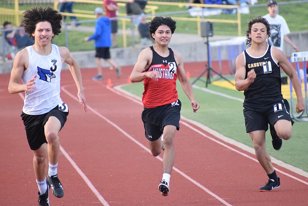 McDonald County's Estaban Martinez-Olvera (center) runs the 100 meter dash  at the Big 8 Conference Track and Field Championships held on May 5 at Monett High School.