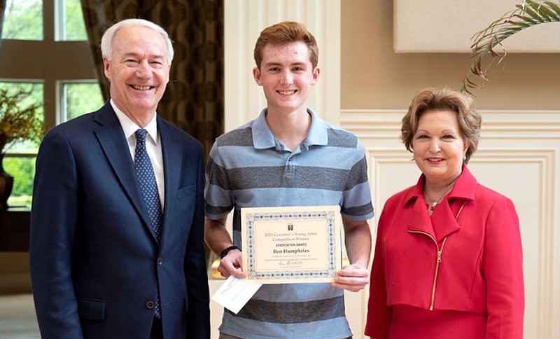 Photo submitted
Ben Humphries (center), a senior at Siloam Springs High School, receives an association award for his watercolor titled The Freedom of Nature from Gov. Asa Hutchinson and First Lady Susan Hutchinson on April 24.
