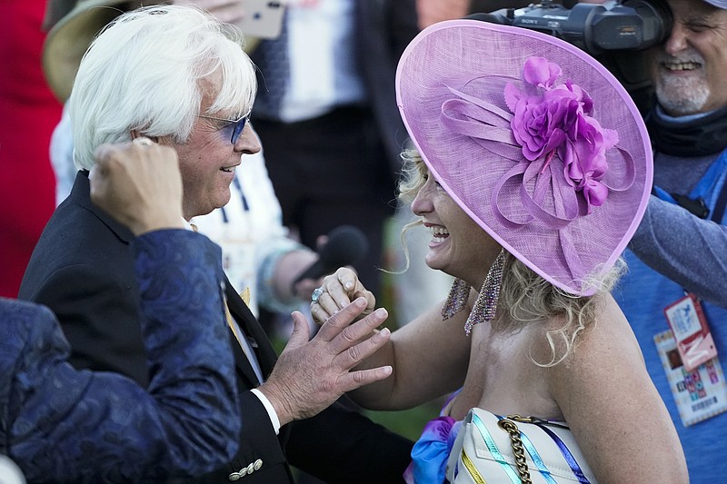 Trainer Bob Baffert is greeted by Leona O'Brien, wife of jockey John Velazquez, after Medina Spirit won the 147th running of the Kentucky Derby horse race at Churchill Downs, Saturday, May 1, 2021, in Louisville, Ky. (AP Photo/Jeff Roberson)