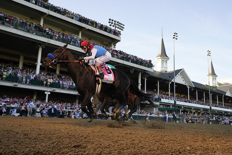 John Velazquez rides Medina Spirit across the finish line to win the 147th running of the Kentucky Derby at Churchill Downs, Saturday, May 1, 2021, in Louisville, Ky. (AP Photo/Jeff Roberson)