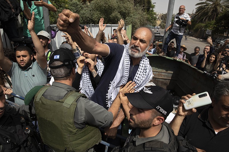Palestinians scuffle with Israeli police officers during a visit by Israeli right wing Knesset members to the Sheikh Jarrah neighborhood of east Jerusalem, Monday, May 10,2021. (AP Photo/Sebastian Scheiner)