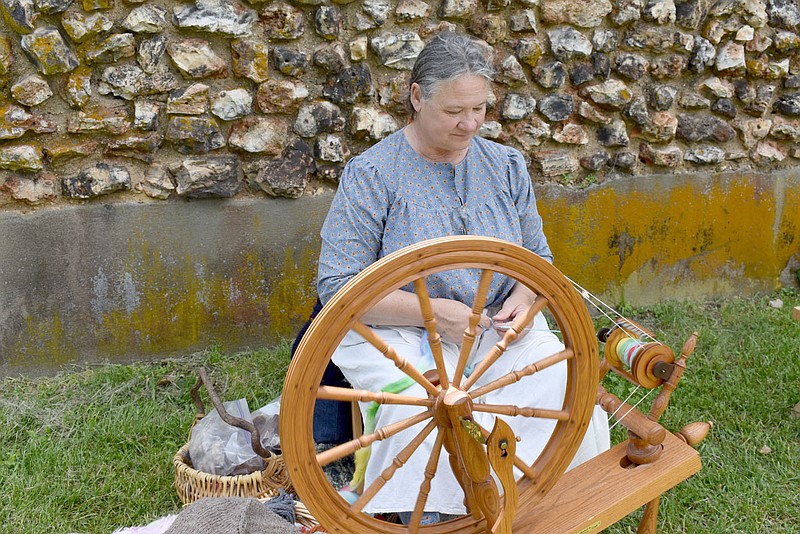 RACHEL DICKERSON/MCDONALD COUNTY PRESS Della Gudgell of Anderson spins wool at a spinning wheel during the New Bethel Heritage Festival on Saturday.