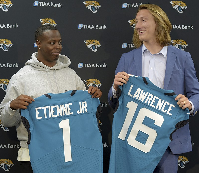 Former Clemson teammates Travis Etienne and Trevor Lawrence pose with their Jacksonville Jaguars jerseys during an April 30 introductory press conference in Jacksonville, Fla. - Photo by Bob Self/The Florida Times-Union via The Associated Press