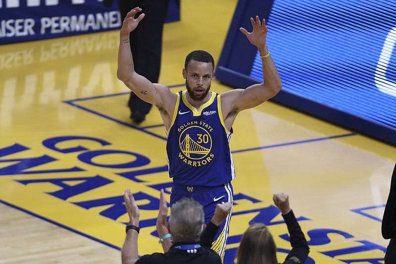 Golden State Warriors' Stephen Curry waves to the crowd after scoring against the Oklahoma City Thunder during the first half of Saturday's NBA game in San Francisco. - Photo by Jed Jacobsohn of The Associated Press