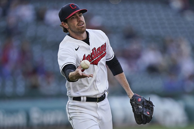 Cleveland Indians starting pitcher Shane Bieber tosses the ball to first base to get Chicago Cubs' Joc Pederson out in the third inning of Tuesday's game in Cleveland. - Photo by Tony Dejak of The Associated Press