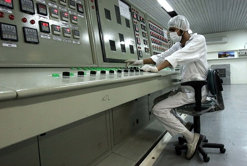FILE - In this Feb. 3, 2007 file photo, a technician works at the Uranium Conversion Facility just outside the city of Isfahan, Iran, 255 miles (410 kilometers) south of the capital Tehran. The United Nations’ atomic watchdog says Iran has enriched uranium to slightly higher purity than previously thought due to “fluctuations” in the process in a report that underscores the challenges diplomats face in ongoing talks to bring the United States back into the nuclear deal with Tehran. (AP Photo/Vahid Salemi, File)