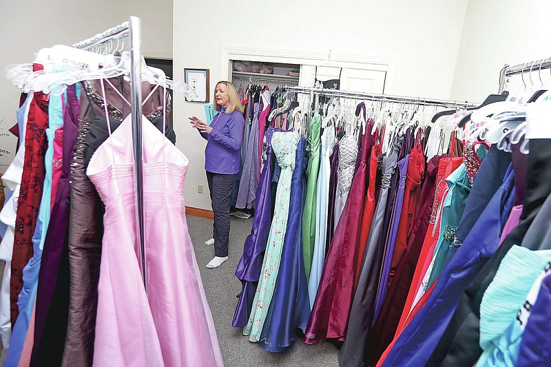 Jean Richardson speaks about the hundreds of prom dresses inside her north Cheyenne, Wyo., home, Tuesday, April 27, 2021. Richardson, the founder of Project Prom Cheyenne, has collected prom dresses for 15 years to give to students. Girls can make appointments to visit her home and find that perfect prom dress, which are mostly donated. (Michael Cummo/The Wyoming Tribune Eagle via AP)