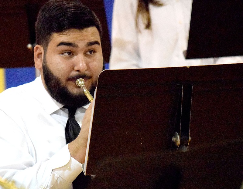 Westside Eagle Observer/MIKE ECKELS
Senior Victor Gonzalez watches Jesse Owens for directions as he performs a trumpet trio with Deegan Brooks and Anderson Almengor (off camera) during the final senior high band piece during the May 11 Bulldog Band Spring Concert at Peterson Gym in Decatur.