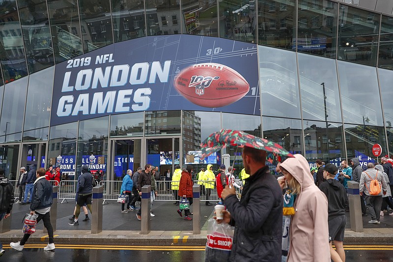 FILE - NFL football fans arrive at Tottenham Hotspur Stadium to watch an NFL football game between the Tampa Bay Buccaneers and the Carolina Panthers in London, in this Sunday, Oct. 13, 2019, file photo. The NFL is returning to London in October. The first game in London since the coronavirus pandemic will be played on Oct. 10 as the Atlanta Falcons face the New York Jets. A week later, the Jacksonville Jaguars meet the Miami Dolphins. Both games will be played at the stadium of Premier League soccer team Tottenham. The Falcons and the Jaguars will be the home teams. (AP Photo/Alastair Grant, File)