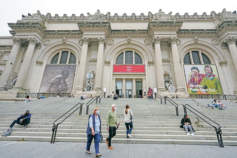 Visitors to the Museum of Modern Art are seen on the museum's staircase, Thursday, April 29, 2021, in New York. In recent weeks, tourism indicators for New York City like hotel occupancy and museum attendance that had fallen off a pandemic cliff have ticked up slightly. It's a welcome sight for a city where the industry has been decimated by the impact of the coronavirus. (AP Photo/Mary Altaffer)