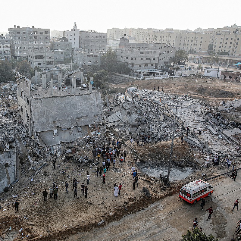 People stand Thursday in the rubble of a Gaza City residential building destroyed by an Israeli airstrike. Early today, Israeli forces struck Gaza in a major assault with airstrikes and ground troops.
(The New York Times/Hosam Salem)
