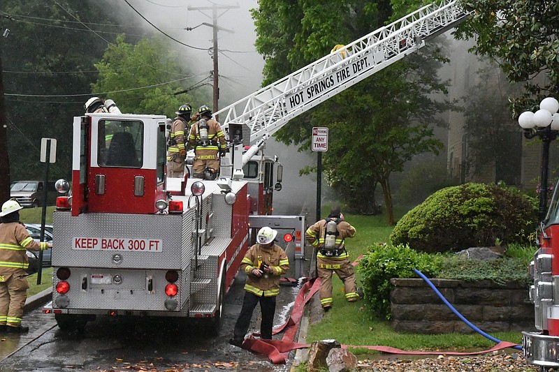 The Hot Springs Fire Department’s aerial truck is used to fight a fire in the 500 block of Prospect Avenue on Tuesday afternoon. - Photo by Tanner Newton of The Sentinel-Record