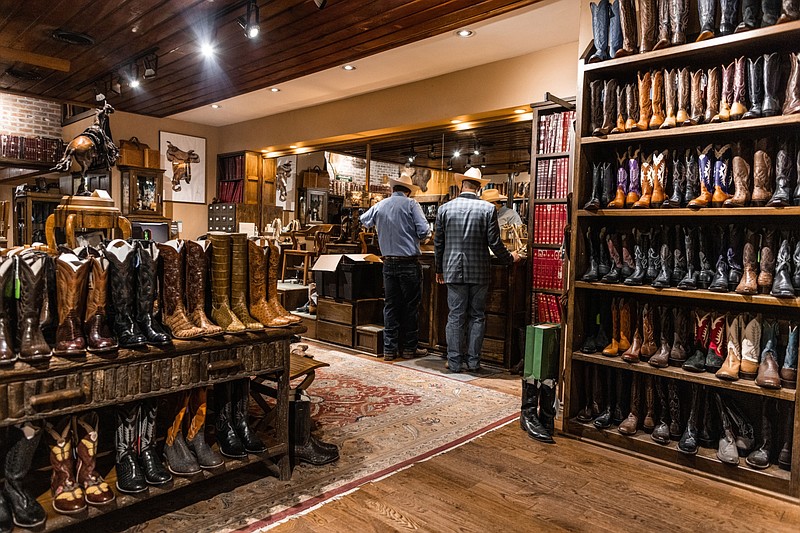 Customers shop for boots at M.L. Leddy's in Fort Worth, Texas, on April 12, 2021. MUST CREDIT: Bloomberg photo by Kathy Tran,