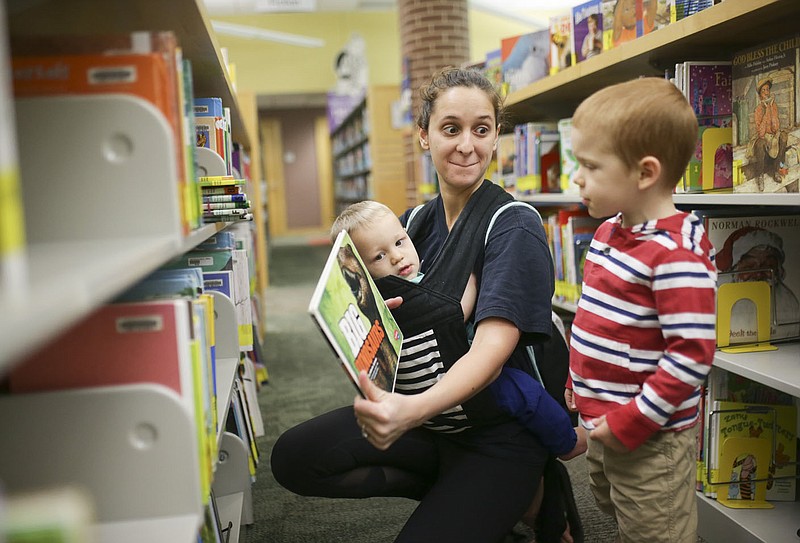 Gina Waters of Bella Vista (center) picks out books with her sons Aethan Waters, 11 months, (from left) and Kota Waters, 3, Thursday, May 13, 2021 at the Bentonville Library in Bentonville. The Bentonville Library Foundation plans to raise 10.5 million to the full needs assessment plan. Check out nwaonline.com/210514Daily/ for today's photo gallery. 
(NWA Democrat-Gazette/Charlie Kaijo)