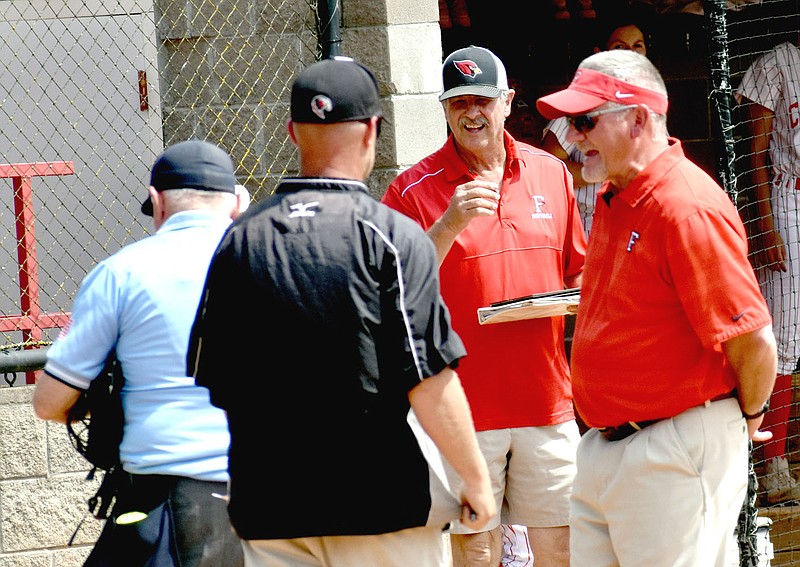 MARK HUMPHREY  ENTERPRISE-LEADER/The competitive spirit comes out in Farmington softball coaches Steve Morgan (center) and Randy Osnes (right) while disputing a call with the plate umpire and Pea Ridge head coach Josh Reynolds during district tournament play. Pea Ridge slipped past the Lady Cardinals, 5-4, in the Class 4A State semifinals Saturday at Morrilton — leaving Farmington one game short of playing in a third straight State softball finals. Osnes and Morgan have coached together for 27 years, two more than Osnes and his wife, Liz, have been married.