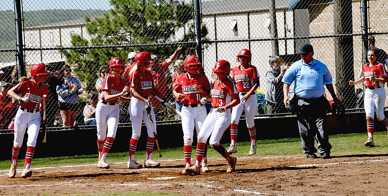MARK HUMPHREY  ENTERPRISE-LEADER/Farmington's softball team players come out to home plate to celebrate as senior Shayley Treat comes in to score. The Lady Cardinals scored early and often while defeating Malvern, 15-0, on Friday to advance to the Class 4A State semifinals on Saturday at Morrilton.