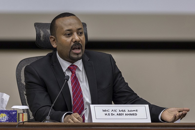 FILE - In this Monday, Nov. 30, 2020 file photo, Ethiopia's Prime Minister Abiy Ahmed responds to questions from members of parliament at the prime minister's office in the capital Addis Ababa, Ethiopia. Ethiopia has again delayed its national election after the head of the national elections board, Birtukan Mideksa, in a meeting with political parties' representatives on Saturday, May 15, 2021 said the June 5 vote in Africa's second most populous country would be postponed until a yet-unknown date. (AP Photo/Mulugeta Ayene, File)