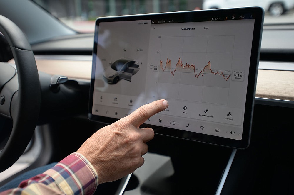 Kris Williams, director of energy services for Ozarks Electric Cooperative Corp. shows a graph of the energy usage of one of the cooperative√çs Tesla Model 3 electric vehicles Wednesday, May 12, 2021, at the cooperative√çs offices in Fayetteville. It can be challenging to find charging stations for electric vehicles in rural areas of Arkansas, but both the state and private companies are working to change that. Visit nwaonline.com/210518Daily/ for today's photo gallery. (NWA Democrat-Gazette/Andy Shupe)