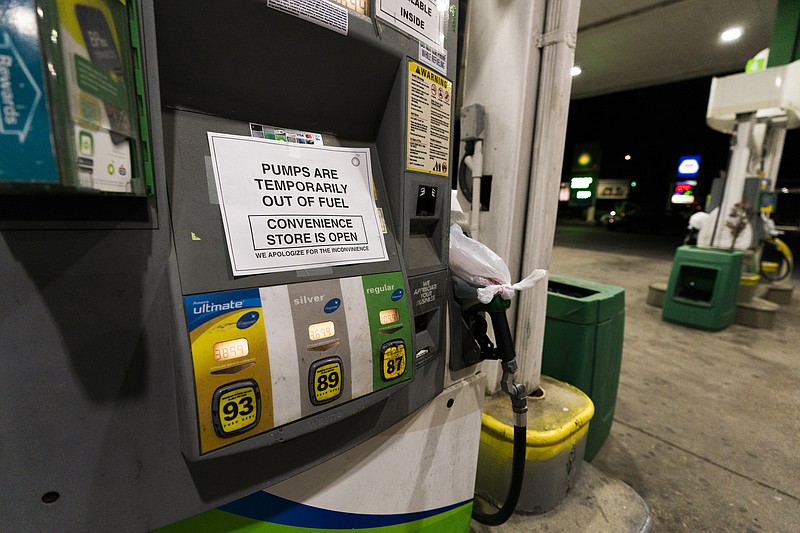 A pump at a gas station in Silver Spring, Md., is out of service, notifying customers they are out of fuel, Thursday, May 13, 2021. Motorists found gas pumps shrouded in plastic bags at tapped-out service stations across more than a dozen U.S. states Thursday while the operator of the nation's largest gasoline pipeline reported making "substantial progress" in resolving the computer hack-induced shutdown responsible for the empty tanks. (AP Photo/Manuel Balce Ceneta)