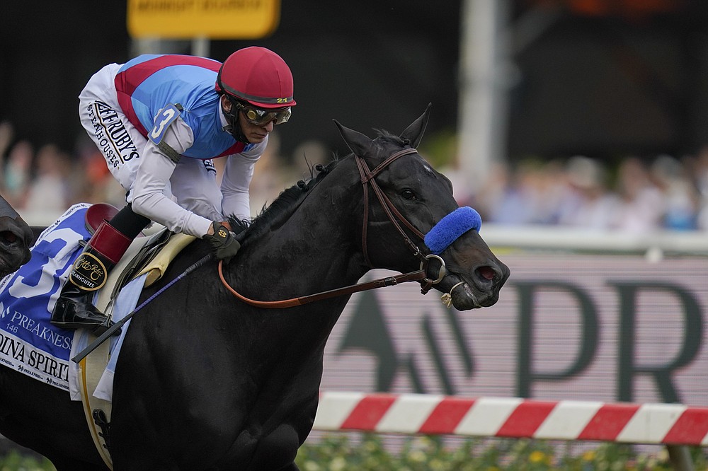 John Velazquez atop Medina Spirit compets in the Preakness Stakes horse race at Pimlico Race Course, Saturday, May 15, 2021, in Baltimore. (AP Photo/Julio Cortez)