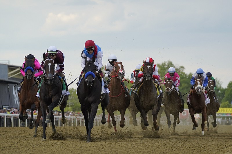 John Velazquez atop Medina Spirit, center left, leads the pack out of the gates during the 146th Preakness Stakes at Pimlico Race Course Saturday in Baltimore. - Photo by Julio Cortez of The Associated Press