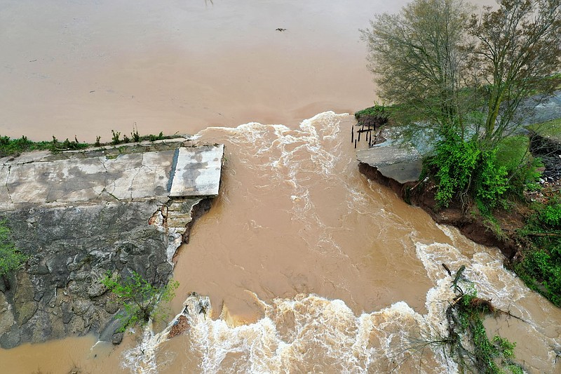 A section of the dam that creates Lake Bella Vista is seen washed away from recent storms. The break is in a section of the dam between to concrete overflow. The main dam gate and over flows became blocked by debris created during the storm. Go to nwaonline.com/210517Daily/ for today's photo gallery.
 (File Photo/NWA Democrat-Gazette/Spencer Tirey)