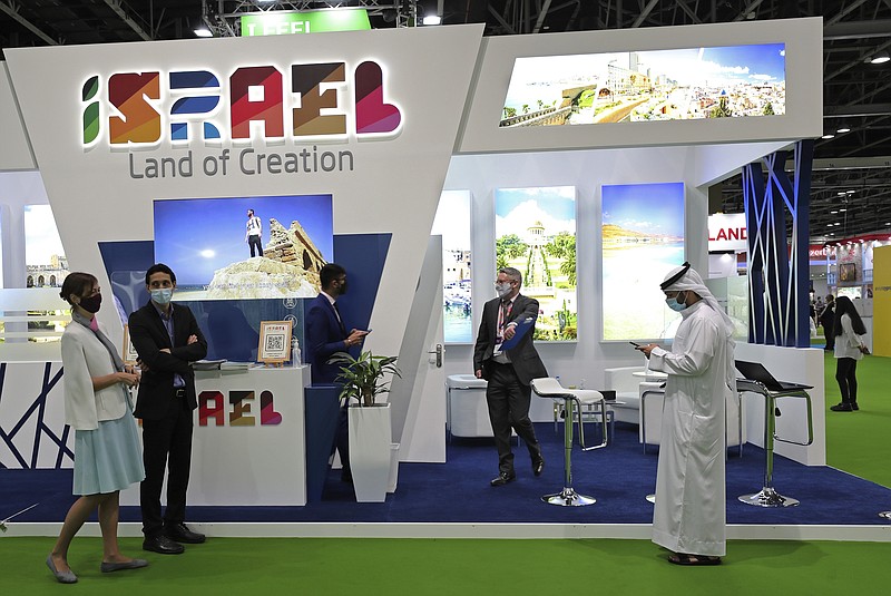 Israeli exhibitors receive visitors at their stand on the opening day of the Arabian Travel Market exhibition, in Dubai, United Arab Emirates, Sunday, May 16, 2021. As violence flares within Israel and on a day in which Israeli airstrikes on Gaza City killed at least 42 people Sunday, it was business as usual for a senior Israeli tourism official in Dubai as she promoted the country as a must-see destination for Muslim visitors.  (AP Photo/Kamran Jebreili)