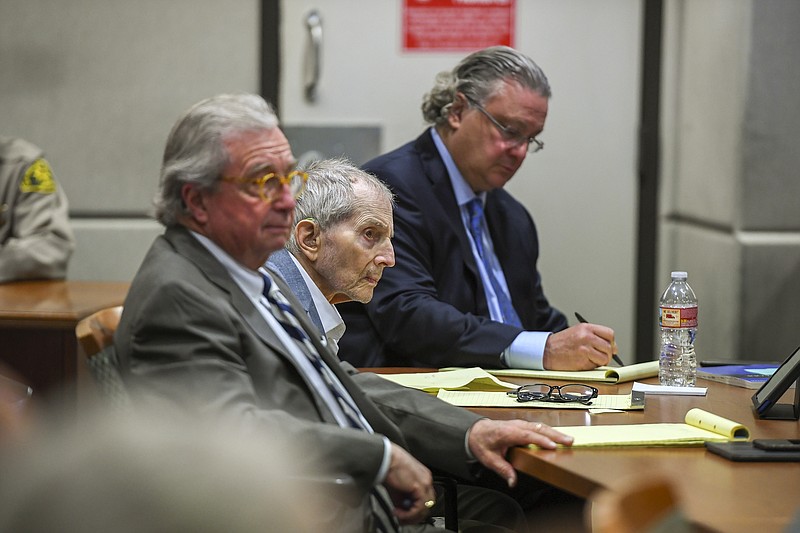 FILE - In this March 5, 2020, file photo real estate heir Robert Durst, middle, sits with his defense attorneys, David Chesnoff, left, and Dick DeGuerin during his murder trial at the Airport Branch Courthouse in Los Angeles. Fourteen months after the murder trial of New York real estate heir Durst was put on hold because of the coronavirus pandemic, jurors are returning to court to see if they can finish the assignment they were given. A Los Angeles judge will question jurors Monday, May 17, 2021, to find out if they can continue to serve in the case that is expected to last four to five months. (Robyn Beck/Pool Photo via AP, File)