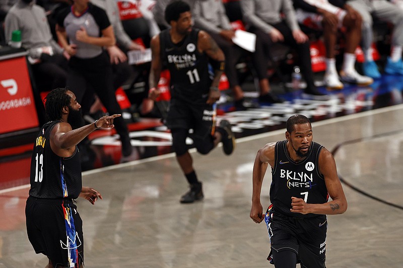 Brooklyn Nets guard James Harden (13), forward Kevin Durant (7) and guard Kyrie Irving (11) run up-court against the Chicago Bulls during the first half of an NBA basketball game Saturday, May 15, 2021, in New York. The Nets won 105-91. (AP Photo/Adam Hunger)