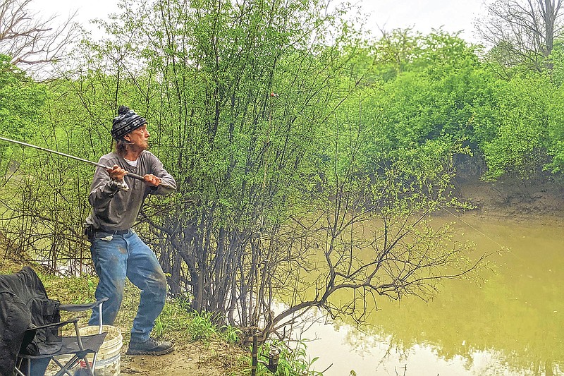 Dwight J. Violette casts a line along the Big Muddy River near Carbondale, Ill.,  on April 28, 2021. Violette said he came to Carbondale after spending more than 20 years in prison.  (Byron Hetzler /The Southern Illinoisan via AP)