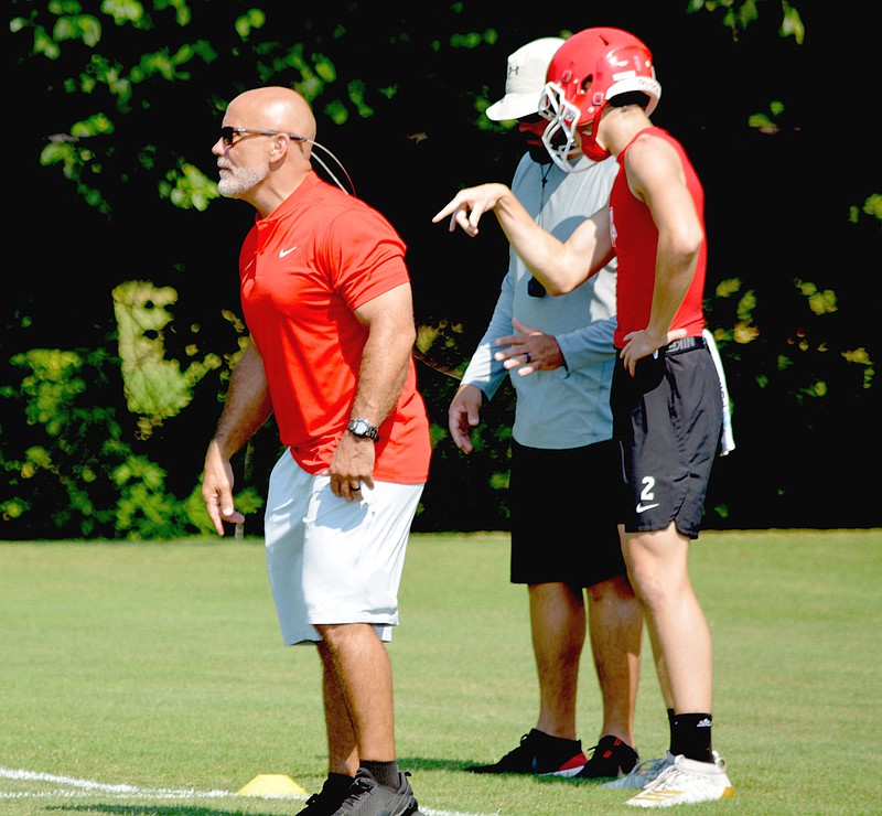 Graham Thomas Special to the Enterprise-Leader/Farmington head football coach J.R. Eldridge watches a play develop while rising sophomore quarterback Cameron Vanzant talks to an assistant coach during the Stateline Shootout 7-on-7 football tournament hosted by Siloam Springs Saturday.