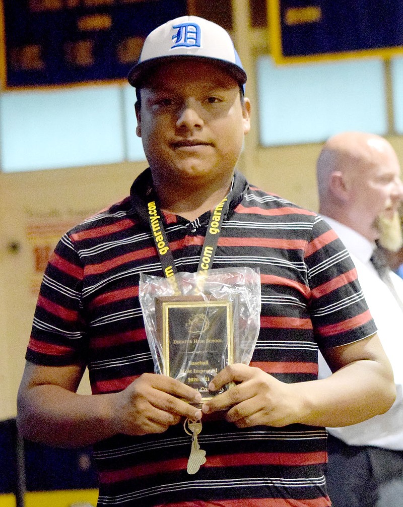 Westside Eagle Observer/MIKE ECKELS
Yeferson Cardona displays his baseball Most Improved Player award he received during the 2021 Bulldog Sports Award program at Peterson Gym in Decatur May 18. Cardona was a member of the 2021 Decatur Bulldog baseball and the 2020-21 basketball teams.