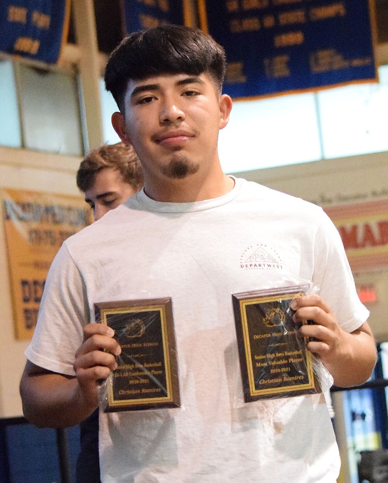 Westside Eagle Observer/MIKE ECKELS

Christian Ramirez displays a pair of basketball awards, 2A-1 All Conference (left) and the Most Valuable Player. he received during the 2021 Bulldog Sports Award program in Decatur May 18. Ramirez was recently name to the 3A All State Soccer team as was the Bulldogs fifth leading scorer with five goals this season.