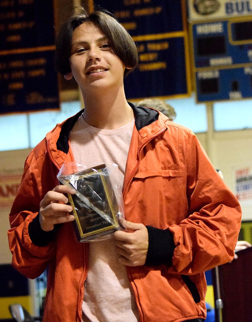 Westside Eagle Observer/MIKE ECKELS
Senior Emmanuel Thao displays his Defensive Player of the Year in soccer award during the Bulldogs Sports Award program at Peterson Gym in Decatur May 18. Thao was named to the 2021 Arkansas All Star Soccer Team as a first alternate as well as the 3A State Tournament Team and 3A All Conference.