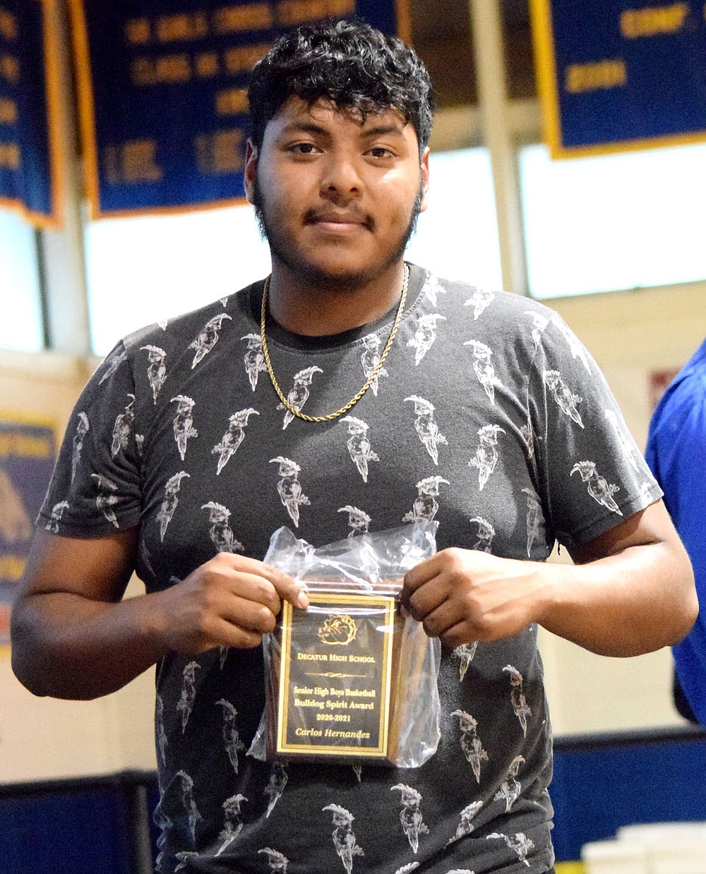 Westside Eagle Observer/MIKE ECKELS
Carlos Hernandez displays his Bulldog Spirit Award in basketball during the 2021 Bulldog Sports Award Program in Decatur May 18. Hernandez was the backbone for the 2021 Decatur Bulldog soccer team leading the offensive drives with 17 goals this season. His efforts earned him a sport on the 3A State Soccer team as well as the Bulldogs Most Valuable Player of the Year award he also received during the sports program.