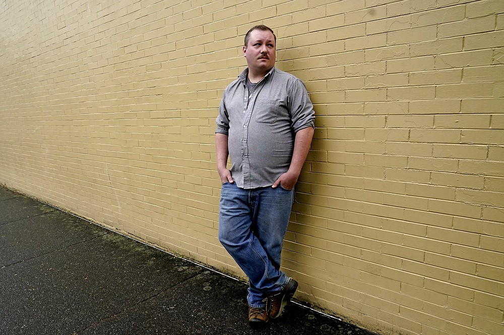 Nate Mullins, a former bartender from Oak, Harbor, Wash., who quit his job last November after clashing with managers over enforcing mask rules, poses for a photo Monday, May 17, 2021, in Mount Vernon, Wash. There's a wild card in the push to return to post-pandemic life: many workers don't want to return to the jobs they once had. Mullins' unemployment checks don't match what he was making at the bar, but they're enough to get by while he looks for jobs that would provide health care and retirement benefits. (AP Photo/Elaine Thompson)
