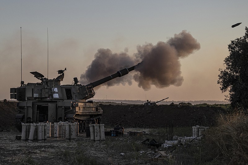 An Israeli artillery unit fires toward targets in Gaza Strip, at the Israeli Gaza border, Tuesday, May 18, 2021. (AP Photo/Tsafrir Abayov)