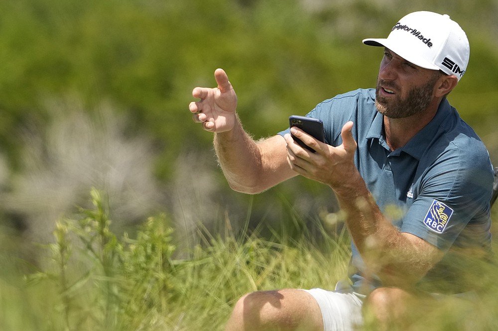 Dustin Johnson waits to tee off on the 11th hole during a practice round at the PGA Championship golf tournament on the Ocean Course Wednesday, May 19, 2021, in Kiawah Island, S.C. (AP Photo/David J. Phillip)