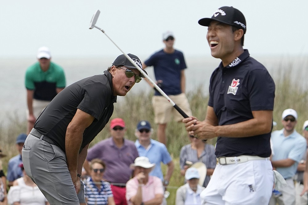 Phil Mickelson, left, misses a putt as Kevin Na, right, reacts on the 14th hole during a practice round at the PGA Championship golf tournament on the Ocean Course Wednesday, May 19, 2021, in Kiawah Island, S.C. (AP Photo/David J. Phillip)