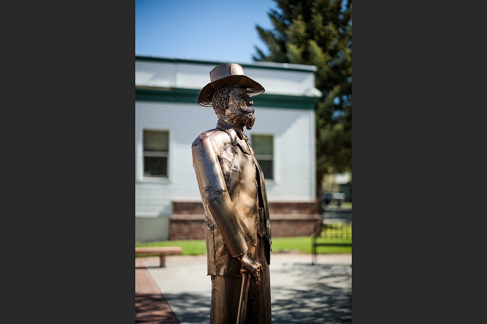 A statue of town founder Abner Weed looks out over downtown Weed, Calif. Would the 19th-century timber baron get a chuckle out of what his name has come to mean? (The New York Times/Max Whittaker)