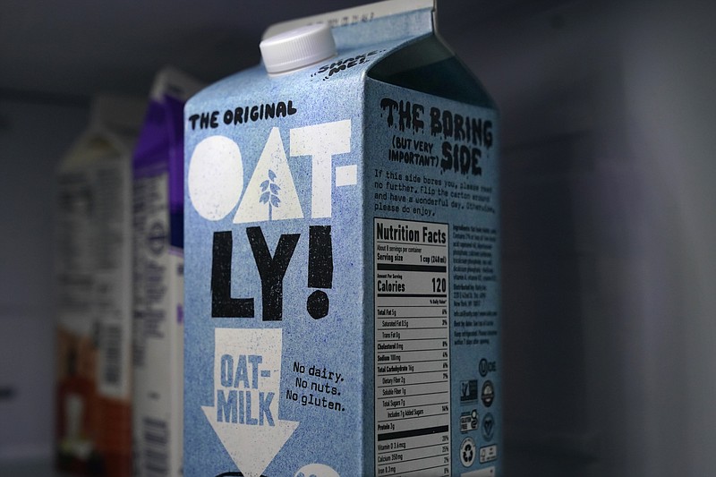 A carton of Oatly oat milk sits in a home refrigerator Tuesday, May 18, 2021, in Bellingham, Wash. Oatly, the world’s largest oat milk company, will raise $1.4 billion in an initial public offering Thursday, May 20 on the Nasdaq stock exchange. (AP Photo/Elaine Thompson)